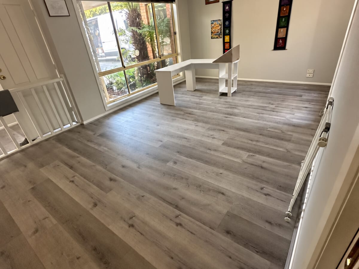 Dark Grey Oak 1005 flooring seen from a doorway into a study, the stair balustrade to the right.