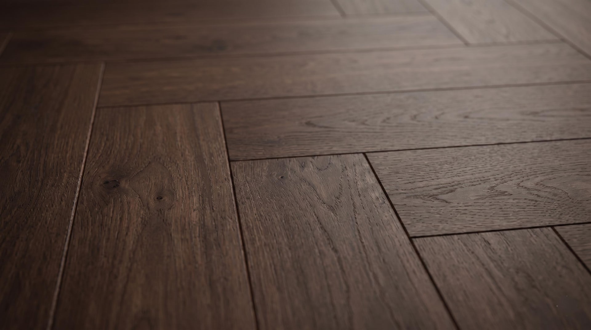 Dark wooden floor planks photographed close up with soft architectural lighting.